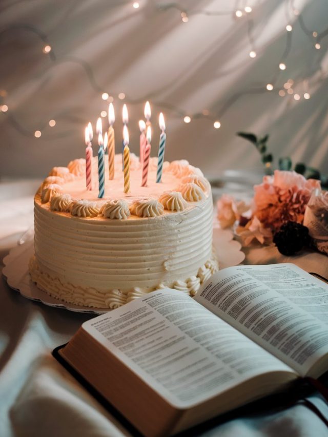 A beautiful birthday cake with glowing candles against a soft background with subtle light rays, an open Bible visible