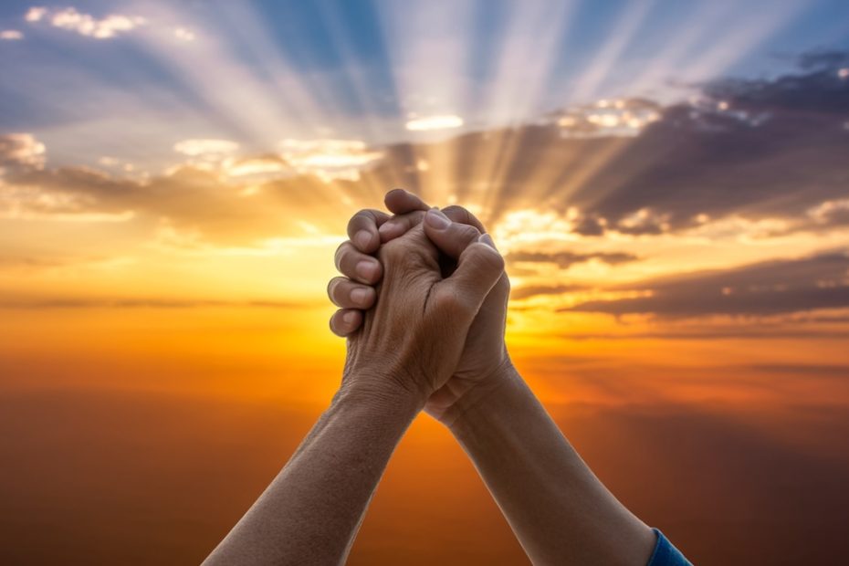 Hands raised in prayer for help and guidance with beautiful sunrise representing God's divine direction and wisdom
