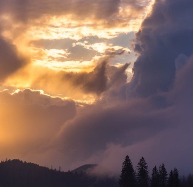 Sunrise breaking through with cross-shaped rays symbolizing freedom from curses through prayer